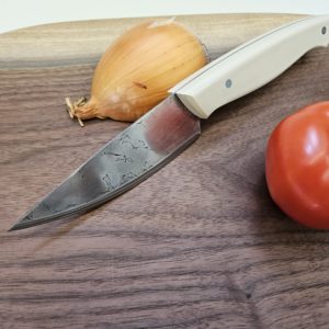 Handmade kitchen knife from recycled saw blade, patterned steel blade.