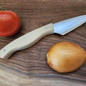 Stainless steel kitchen knife with curvy white handle, handcrafted in Canada